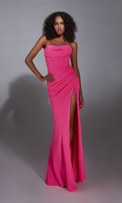A woman models the Aerie Couture 343 Long Prom Dress, a bright pink floor-length gown featuring a corset bodice and thigh-high slit, against a plain gray background.