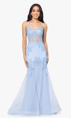 A woman models the Blondie Nites Long Mermaid Prom Dress 3448BN in light blue, featuring embroidered lace appliques, sheer panels, and a corset-style waist, standing against a plain white background.