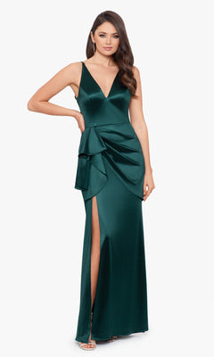 Woman wearing the Blondie Nites Side Drape Long Formal Dress 3458BN—a deep green satin, sleeveless gown with v-neckline, side drape detail, and thigh-high slit—perfect for prom—paired with silver high-heeled sandals.