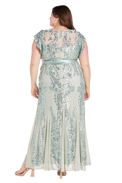 A woman stands with her arms relaxed at her sides, shown from the back in the Plus-Size Sage Green Formal Dress: R&M Richards 3465W—a light, floor-length gown with silver sequin embellishments for an elegant look.