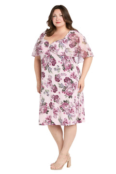 A woman wearing the R&M Richards 3467W plus-size pink party dress with sheer flutter sleeves and nude heeled sandals, standing against a white background.