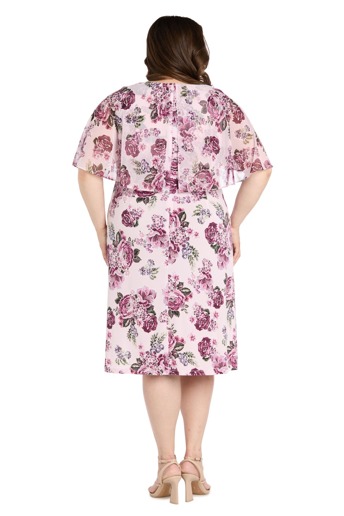 A woman faces away, wearing the Plus-Size Pink Party Dress: R&M Richards 3467W with short sleeves, a knee-length floral pattern, and beige heeled sandals.