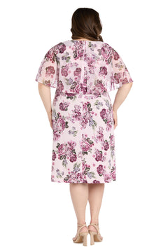 A woman faces away, wearing the Plus-Size Pink Party Dress: R&M Richards 3467W with short sleeves, a knee-length floral pattern, and beige heeled sandals.