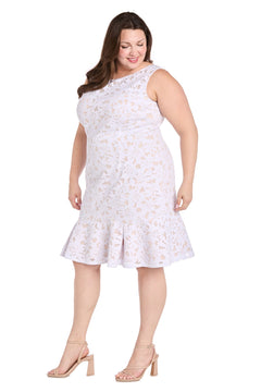 Woman models the R&M Richards 3506W Plus Knee Length Party Dress, featuring a sleeveless floral design and ruffled hem, paired with nude heels against a plain white background.