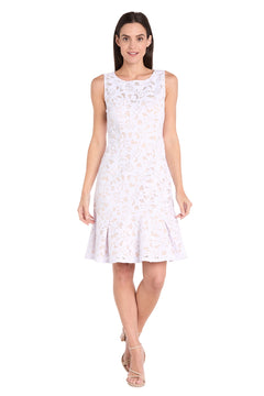 A woman wearing the Petite White Lace Party Dress by R&M Richards (3506P)—a sleeveless, knee-length cocktail dress with a floral lace pattern and flared hem—stands facing forward with a neutral expression.