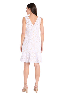 Woman standing and facing away, wearing the Petite White Lace Party Dress: R&M Richards 3506P, paired with beige heeled sandals.