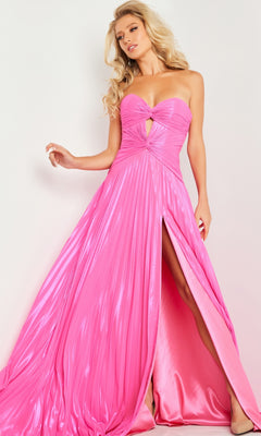A woman stands against a plain background wearing the Jovani 36461 strapless long pleated prom dress in shiny pink, featuring a sweetheart neckline, center cutout, and high front slit.