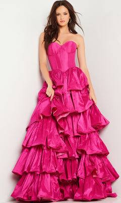 A woman poses in the Jovani 36619 Strapless Ruffled Prom Ball Gown, a bright pink formal dress featuring a fitted bodice and a tiered, voluminous skirt, set against a plain light background.