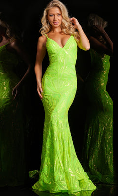 A woman in the Long Sequin-Print Mermaid Prom Dress: Jovani 36656, a fitted floor-length neon green gown, stands against a black background with her reflection visible.