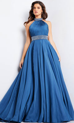 A woman stands against a plain light background, wearing the Long Prom Dress 36749 by Jovani—a sleeveless, floor-length a-line gown with a pleated bodice, beaded waistband, and flowing skirt.