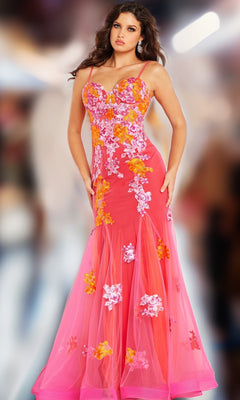 A woman poses on a blurred background wearing the Long Prom Dress 36843 by Jovani, a pink strapless gown with orange and white floral embroidery and a sweetheart neckline.