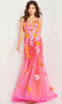 A woman wears the Long Prom Dress 36843 by Jovani—a fitted, floor-length pink mermaid tulle gown with orange and white floral embroidery, a sweetheart neckline, and a sheer overlay.