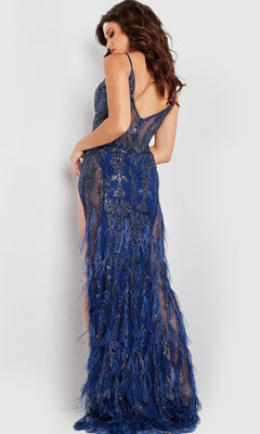 A woman poses with her back to the camera in the Long Prom Dress 36885 by Jovani, featuring a deep blue hue, floor-length design, intricate beadwork, and feather details.