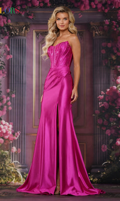 A woman models the Lace-Up Long Corset Prom Dress: Colors Dress 3692, featuring a hot pink satin skirt with a thigh-high slit and a sparkling beaded corset bodice, set against a floral and column backdrop.