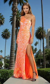 Woman in an orange dress standing outdoors with palm trees in the background