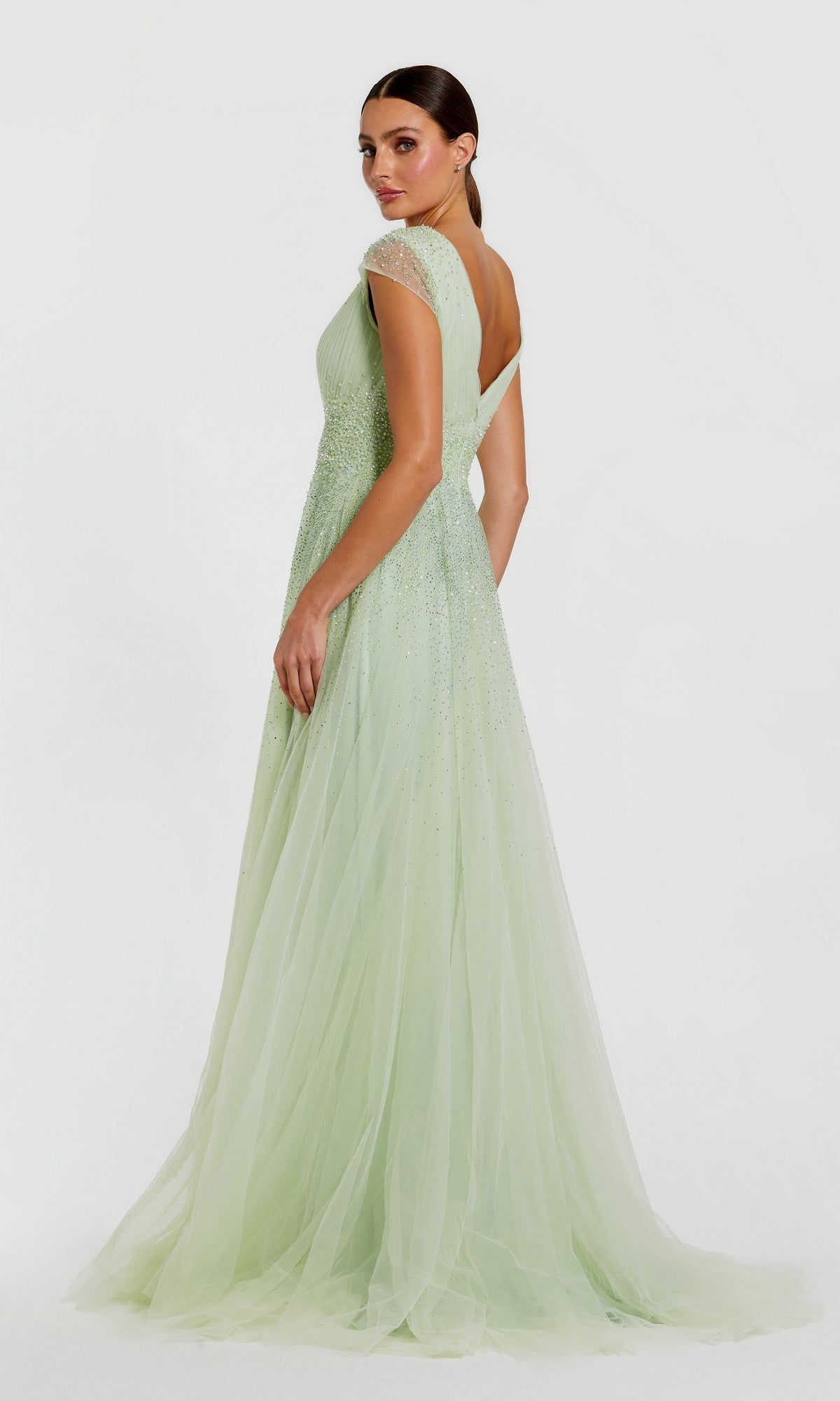 Woman in a pale green Mac Duggal 37018 long formal dress with cap sleeves and an open back, standing against a plain white background.