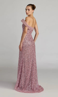 A woman poses against a plain light background, looking over her shoulder in the shimmering, off-the-shoulder, floor-length pink Long Formal Dress: Mac Duggal 37085.