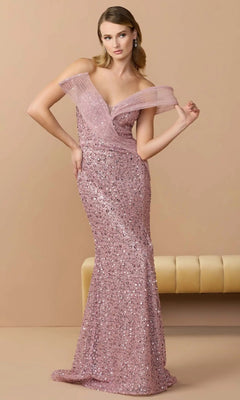 A woman in the Mac Duggal 37085 long formal dress, a floor-length off-the-shoulder pink sequin gown, stands before a beige backdrop beside a cream-colored bench.