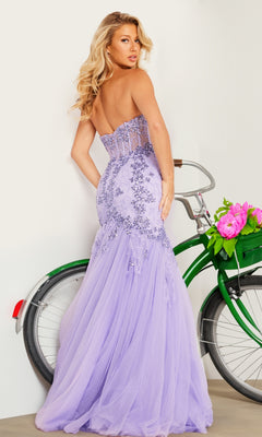 A woman in the Long Prom Dress 37249 by Jovani—a strapless sweetheart lavender lace gown—stands beside a green bicycle with a basket of pink flowers, facing away for an elegant, dreamy prom look.