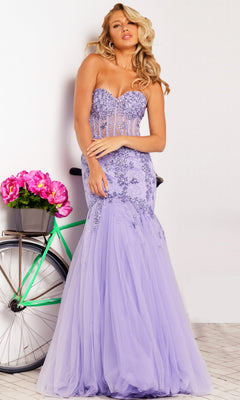 A woman in the Long Prom Dress 37249 by Jovani, featuring a strapless sweetheart mermaid design with floral embroidery, stands beside a bicycle decorated with pink flowers.