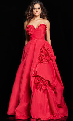 A woman stands against a black background wearing the Long Prom Dress 37266 by Jovani, a strapless, floor-length red ball gown adorned with large fabric roses on the bodice and skirt.