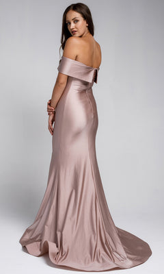 Woman in the Sleek Simple Off-the-Shoulder Long Prom Dress 373, a floor-length, light pink satin gown, stands and looks over her shoulder against a plain background.