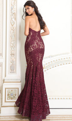 A person wearing a Strapless Long Lace Prom Dress; Jovani 37334, a backless, floor-length burgundy lace gown with a mermaid silhouette and a sweetheart neckline.