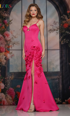 A woman stands before a floral backdrop in a vibrant pink Cut-Out Long Floral Prom Dress: Colors Dress 3736, a floor-length gown with floral appliqué details and a bold thigh-high slit.