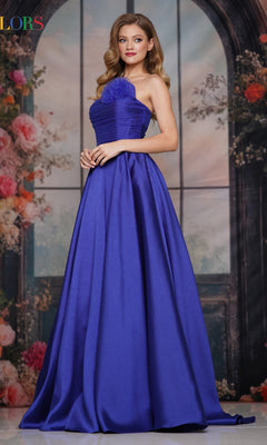 A woman stands before a floral archway backdrop, wearing the Strapless Long A-Line Prom Dress Colors Dress 3737 in sapphire.