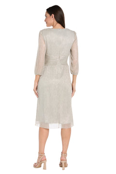 A woman faces away, wearing the R&M Richards 3741 Metallic Knee-Length Party Dress with three-quarter sleeves and beige heeled sandals.