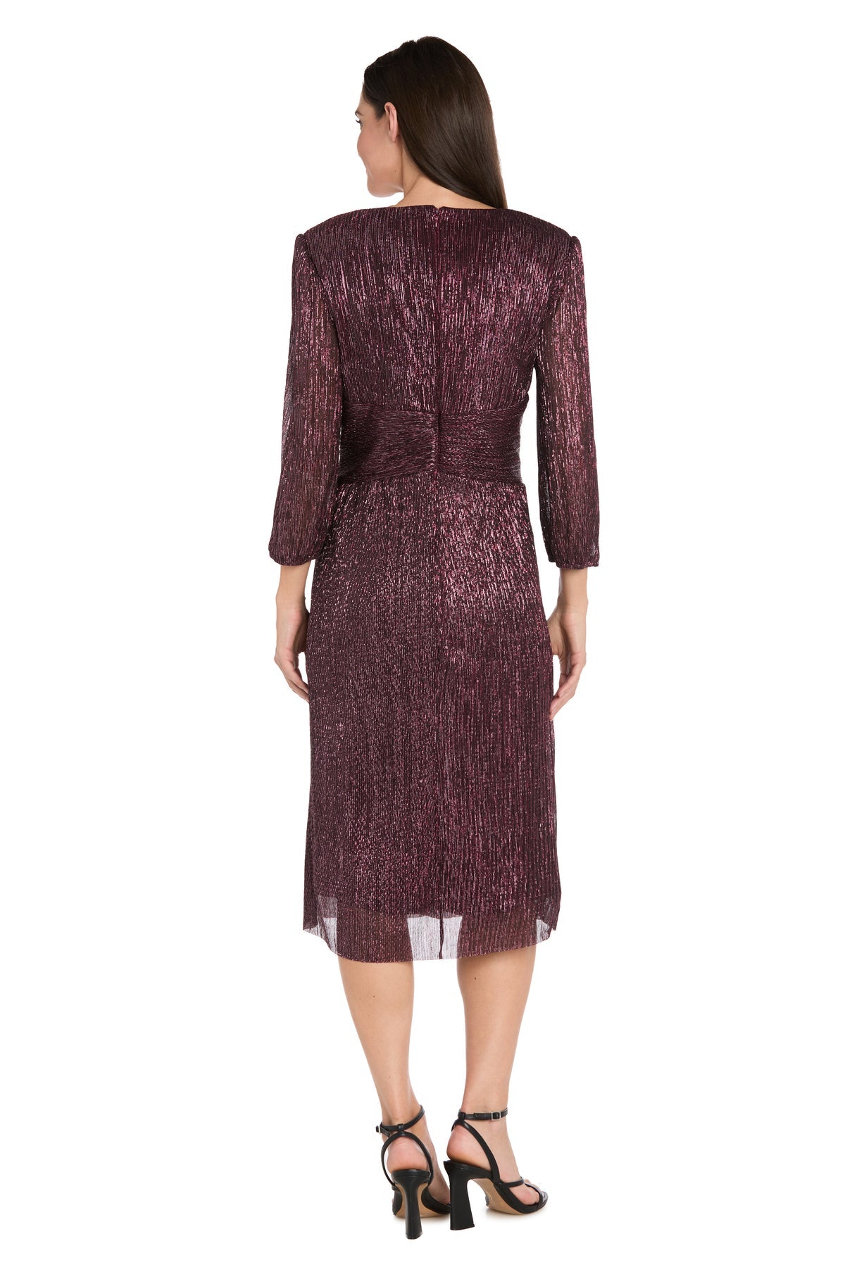 A woman faces away, wearing the R&M Richards 3741 Metallic Knee-Length Party Dress in burgundy with long sleeves, paired with black heeled sandals against a white background.