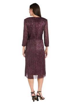 A woman faces away, wearing the R&M Richards 3741 Metallic Knee-Length Party Dress in burgundy with long sleeves, paired with black heeled sandals against a white background.