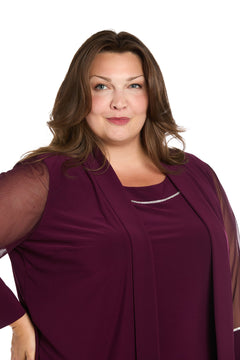 Woman with long brown hair wears the affordable R&M Richards 3747W Short Plus-Size Jacket Party Dress, featuring a burgundy top with sheer sleeves, standing against a white background and looking at the camera.