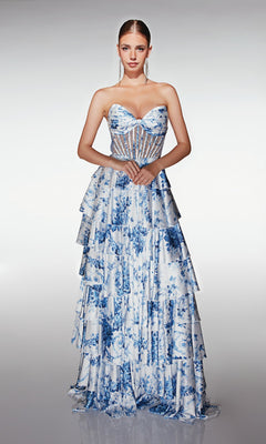 Woman modeling the Aerie Couture 374 long prom dress, featuring blue and white floral print, sheer corset bodice, and tiered ruffle A-line skirt, standing against a plain light background.