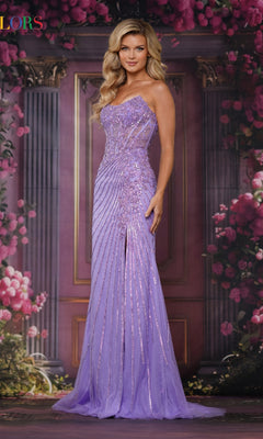 A woman wearing the Strapless Long Beaded Prom Gown: Colors Dress 3762 stands before a floral and column backdrop, her sparkling lavender gown shimmering with sequins.