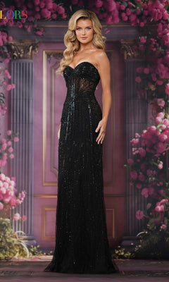 A woman wears the Colors Dress 3765, a strapless black sequined long prom gown with a sheer corset bodice, standing before a pink floral and ornate architectural backdrop.