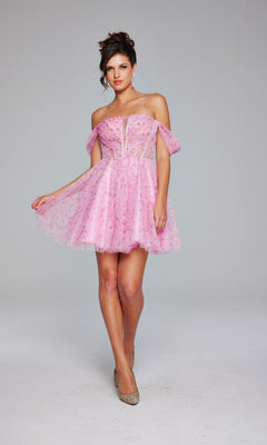 A woman models the Jovani Off-Shoulder Short Pink Hoco Dress 38000, featuring sheer panels and puffed sleeves, set against a plain light gray background.