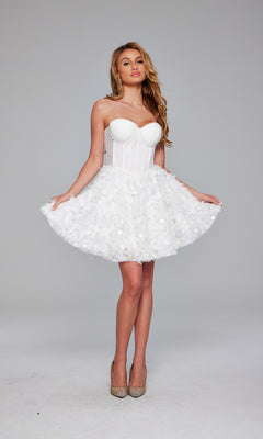 A woman poses against a plain background in the Jovani Strapless Short White Hoco Dress 38248, featuring a fitted bodice and flared skirt, paired with sparkly high heels.