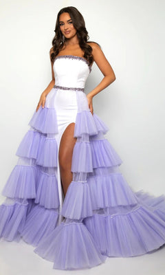 Woman models the Ava Presley 38334 Strapless Two-Tone Prom Dress in White/Lilac, with a jeweled belt, layered tulle ruffles, high slit, and long train, posing against a simple backdrop.