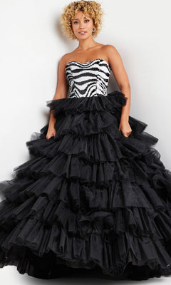 A woman models the Jovani Black White Long Ruffled Prom Dress 38360, featuring a zebra-patterned strapless bodice and a dramatic black ruffled tulle skirt, against a plain background.