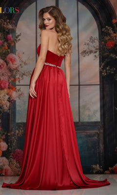A woman models the Strapless Velvet Prom Gown: Colors Dress 3861, posing with her back slightly turned before a floral and window-themed backdrop.