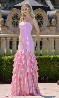 Woman wearing a pink mermaid-style dress with ruffled layers in an outdoor setting.
