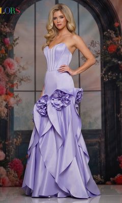 A woman poses before a floral backdrop in the Colors Dress 3880—a strapless long prom dress with a fitted corset bodice and dramatic ruffled 3D rosette appliqués on its light purple fabric.