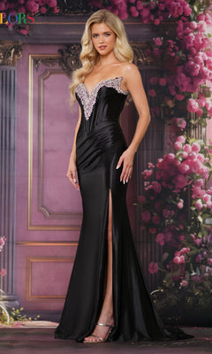 A woman wearing the Colors Dress 3883, a long black strapless satin prom gown with a thigh-high slit and embellished v-neckline, stands before a pink floral ornate backdrop.