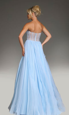 A woman with blonde hair in an updo wears the Jovani 38946 long prom dress, a strapless tulle ballgown with floral ruffle accents, standing with her back to the camera against a plain background.