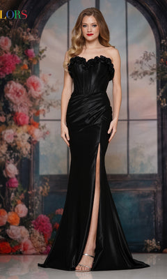 A woman wears the Strapless Long Rosette Prom Gown: Colors Dress 3895, featuring a sweetheart neckline and thigh-high slit, as she stands indoors against a floral and window backdrop.