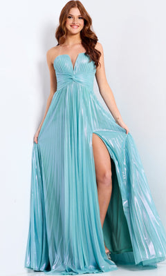 A woman wears the Jovani 39023 long prom dress in mint, featuring a strapless shimmery pleated bodice, high slit, and flowing fabric, standing against a plain light background.