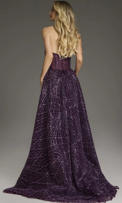 A woman with long blonde hair is seen from the back wearing the Jovani 39029 Long Formal Dress—a strapless, floor-length purple gown featuring a sparkling geometric pattern.
