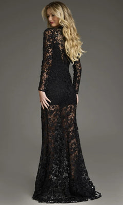 A woman faces away, wearing the Jovani 39034 long formal dress—this floor-length evening gown features long sleeves, sheer detailing, and delicate beaded lace embroidery that enhances its elegance. Her long blonde hair is styled in loose waves against a neutral gray background.