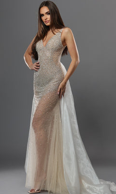 A woman wearing the Jovani 39043 long formal dress in nude/off white—a sleeveless, floor-length gown adorned with crystal embellishments, featuring sheer panels and a long, flowing train—poses against a plain gray background.
